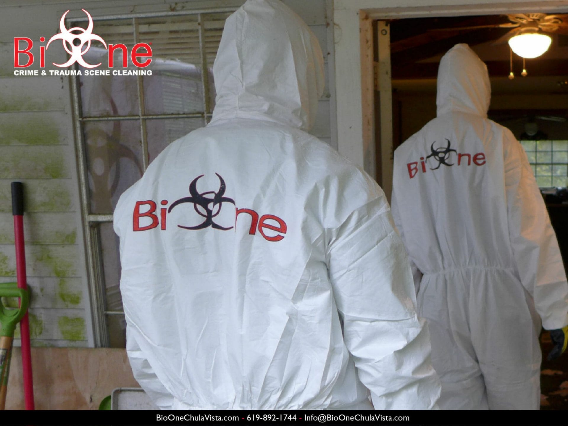 Image shows Bio-One restoration technicians dressed in full PPE entering a house.